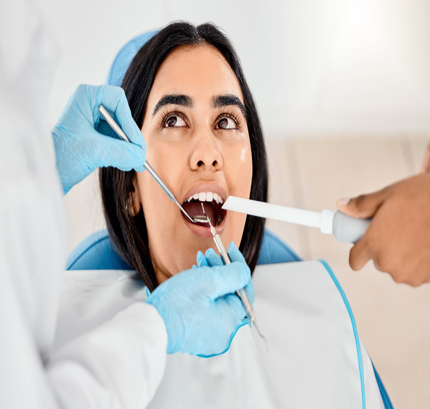 Dentist, woman and patient at a clinic with medical and healthcare for teeth whitening. Mirror, orthodontist and female person with wellness and dental work tool in mouth with care and cleaning