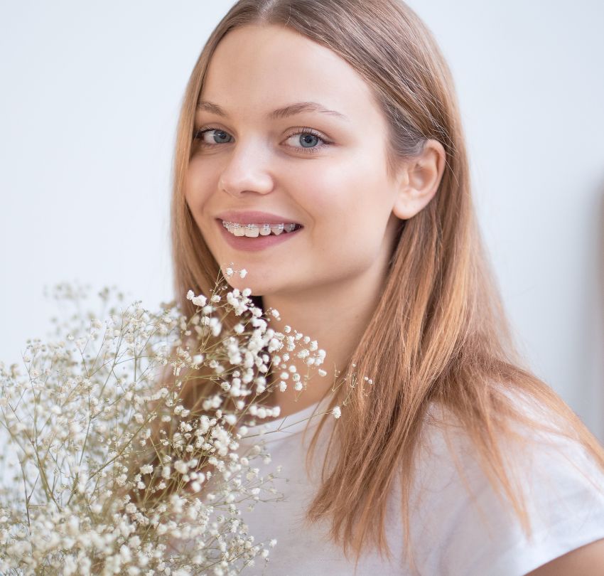 A woman gently cradles a bunch of baby's breath, highlighting the beauty of this delicate flower in a serene environment.