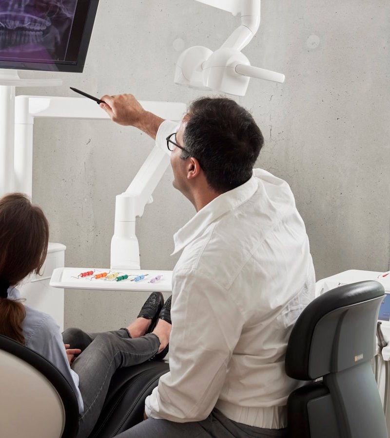 Dentist performing preventive dental exam on patient in Boulder CO